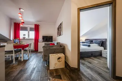 a bedroom with a bed and a dining room with a table at Perugia Moxy TE&AM Old Town Parking gratis in Kraków
