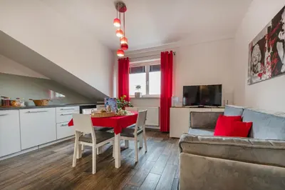 a kitchen and living room with a table and a couch at Perugia Moxy TE&AM Old Town Parking gratis in Kraków