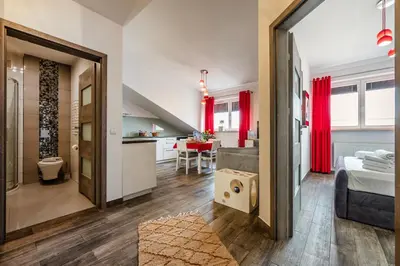 a bedroom with a bed and a kitchen with a table at Perugia Moxy TE&AM Old Town Parking gratis in Kraków