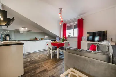 a kitchen and living room with a couch and a table at Perugia Moxy TE&AM Old Town Parking gratis in Kraków