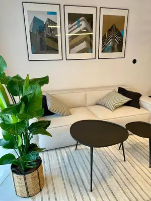 a living room with a couch and a table at Premium Loft Apartments-City Center Parking by Urban Escape in Kraków