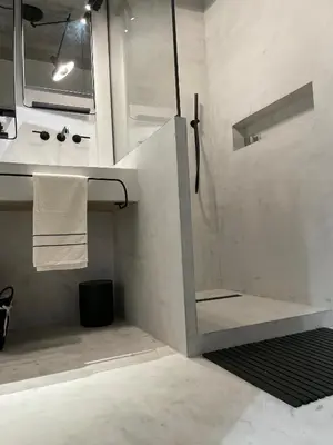 a white bathroom with a shower and a sink at Premium Loft Apartments-City Center Parking by Urban Escape in Kraków