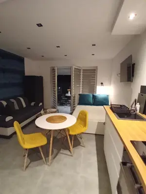 a room with a bed and a table and chairs at Viva Apartments in Oświęcim