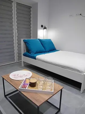 a room with a bed and a coffee table at Viva Apartments in Oświęcim