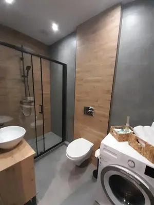 a bathroom with a shower and a toilet and a sink at Viva Apartments in Oświęcim