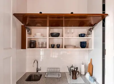 a kitchen with white cabinets and a sink at Once Upon a Time in Cracow - Old Town Apartment in Kraków