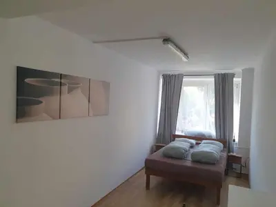 a bedroom with a bed with two pillows on it at Rooms in City Center Kraków in Kraków
