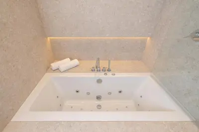 a bath tub in a bathroom with a sink at Słowackiego Elegant Apartment Kraków by Noclegi Renters in Kraków