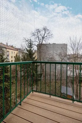 a balcony with a fence and a view of a building at Słowackiego Elegant Apartment Kraków by Noclegi Renters in Kraków