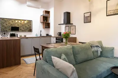 a tiny house with a kitchen and a staircase at Tyzenhauz Apartments Siemiradzkiego Street in Kraków