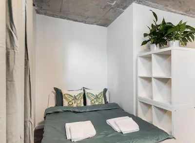 a bedroom with a green bed with towels on it at NEW place next to Vistula & Wawel Castle in Kraków
