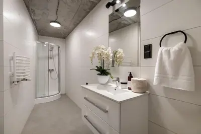 a white bathroom with a sink and a shower at NEW place next to Vistula & Wawel Castle in Kraków