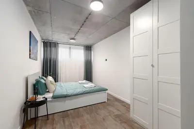 a bedroom with a bed in a room at NEW place next to Vistula & Wawel Castle in Kraków