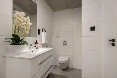 a white bathroom with a sink and a toilet at NEW place next to Vistula & Wawel Castle in Kraków