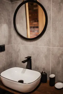 a bathroom with a white sink and a mirror at Domek przy szlaku in Rabka-Zdroj