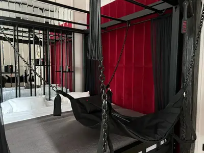 a hammock in a room with a red wall at Exclusive BDSM Apartment Kraków - ADULTS ONLY in Kraków