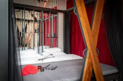 a bedroom with a bunk bed with red curtains at Exclusive BDSM Apartment Kraków - ADULTS ONLY in Kraków
