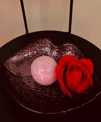 a heart shaped cake with a red rose on it at Exclusive BDSM Apartment Kraków - ADULTS ONLY in Kraków