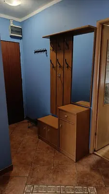 a room with a dresser and a mirror on a wall at Radzikowskiego 100B in Kraków