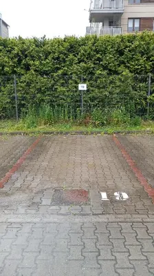 an empty parking lot next to a fence at Radzikowskiego 100B in Kraków