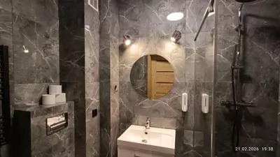 a bathroom with a sink and a mirror at Radzikowskiego 100B in Kraków
