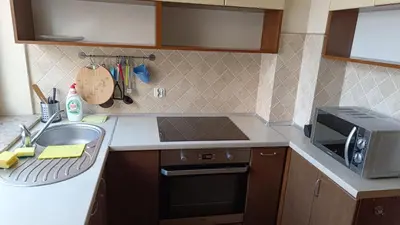 a kitchen with a sink and a microwave at Radzikowskiego 100B in Kraków
