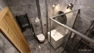a bathroom with a sink and a toilet and a mirror at Radzikowskiego 100B in Kraków
