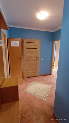an empty room with blue walls and a door at Radzikowskiego 100B in Kraków