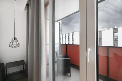 a room with a sliding glass door with a view of a building at Apartamenty Platinex 1 in Kraków