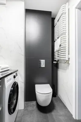 a bathroom with a toilet and a washing machine at Apartamenty Platinex 1 in Kraków