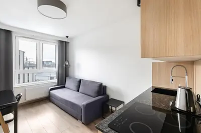 a living room with a desk and a table at Apartamenty Platinex 1 in Kraków