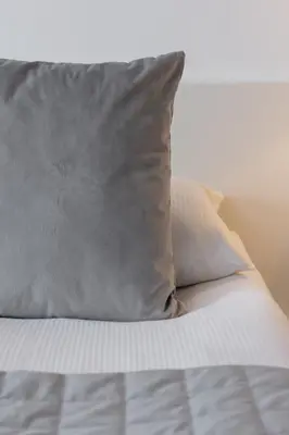 a pillow sitting on top of a bed at Spacious & Cozy Apartment Grzegórzecka by Noclegi Renters in Kraków