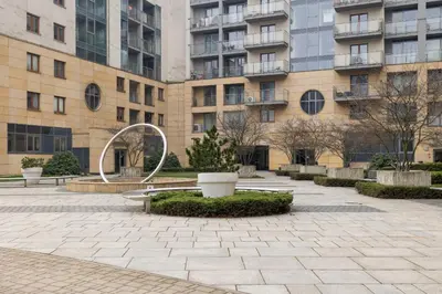 a courtyard in front of a building with a fountain at Spacious & Cozy Apartment Grzegórzecka by Noclegi Renters in Kraków