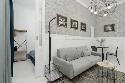 a living room with a couch and a table at Dietla One Bedroom Apartments with Air Conditioning & Balcony by Noclegi Renters in Kraków