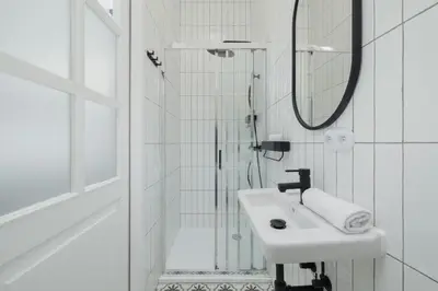 a white bathroom with a sink and a mirror at Dietla One Bedroom Apartments with Air Conditioning & Balcony by Noclegi Renters in Kraków