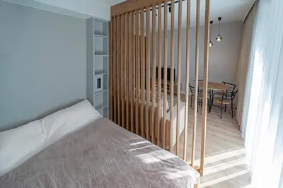 a bedroom with a bed and a dining room table at Apartament Kościuszki 47m44 in Kraków