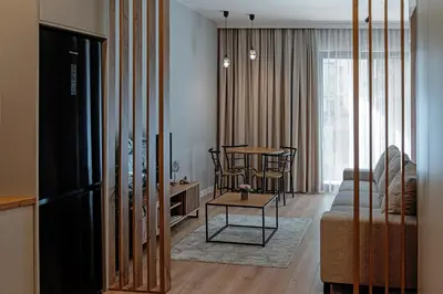 a living room with a couch and a table at Apartament Kościuszki 47m44 in Kraków