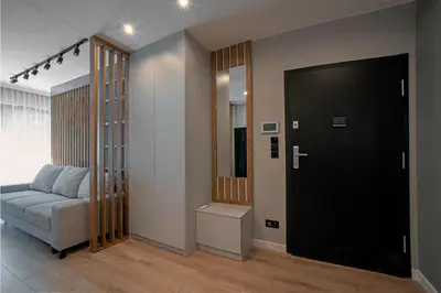 a living room with a couch and a door at Apartament Kościuszki 47m44 in Kraków