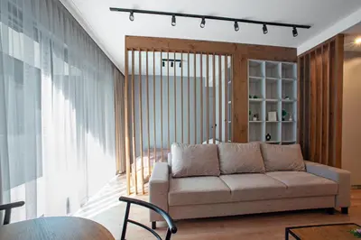 a living room with a couch and a large window at Apartament Kościuszki 47m44 in Kraków