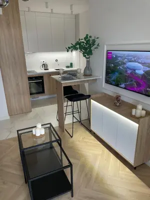 a living room with a large television and a table at Imperial Citi Apartament in Kraków