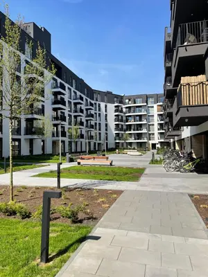 a large apartment building with a park in front of it at Imperial Citi Apartament in Kraków