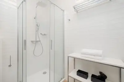 a white bathroom with a shower and a sink at Beautiful & Stylish Apartaments Dietla with Air Conditioning by Noclegi Renters in Kraków