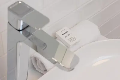 a bathroom with a toilet and towels on a shelf at Beautiful & Stylish Apartaments Dietla with Air Conditioning by Noclegi Renters in Kraków