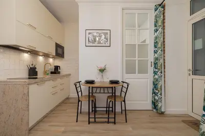 a kitchen with a small table and chairs at Beautiful & Stylish Apartaments Dietla with Air Conditioning by Noclegi Renters in Kraków