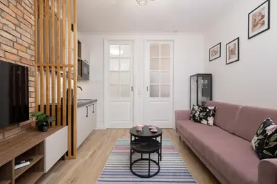 a living room with a couch and a table at Beautiful & Stylish Apartaments Dietla with Air Conditioning by Noclegi Renters in Kraków