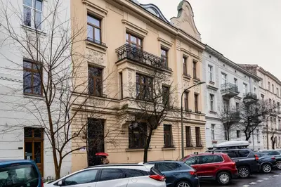 a group of cars parked in front of a building at Park Strzelecki Two-Level Apartment by BookingHost in Kraków