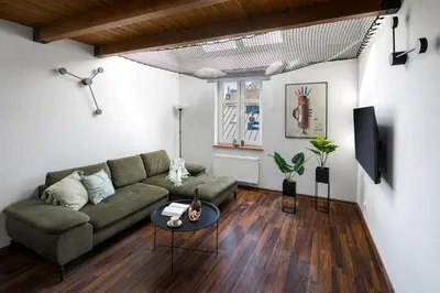a living room with a couch and a table at Corner House Residence in Kraków