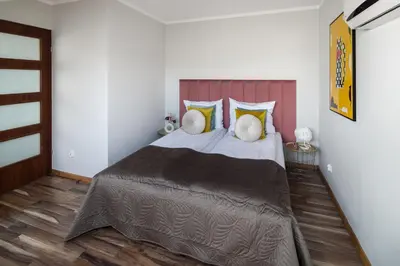a bedroom with a large bed in a room at Corner House Residence in Kraków