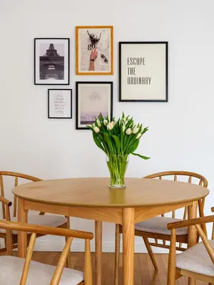 a dining room table with a vase of flowers on it at Modern Central Apartment w. parking by Tyzenhauz in Kraków