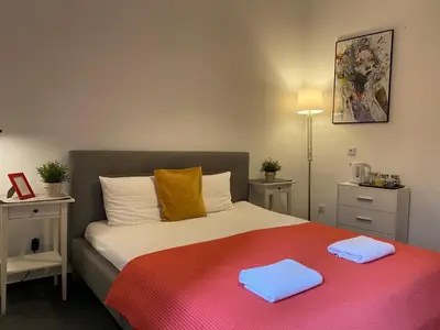 a bedroom with a bed with two towels on it at Millenium Apartments in Kraków